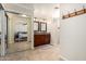 Bathroom view featuring double sinks and a sliding mirror closet that reflects the main bedroom at 1630 W Calle Del Norte --, Chandler, AZ 85224