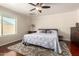 Comfortable bedroom with ceiling fan, wood floors, area rug, and a window for natural light at 1630 W Calle Del Norte --, Chandler, AZ 85224