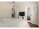 Bright bedroom featuring ceiling fan, wood floors and a mirror reflecting the main bedroom at 1630 W Calle Del Norte --, Chandler, AZ 85224