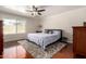 Bright bedroom with ceiling fan, wood floors, area rug, and a large window for natural light at 1630 W Calle Del Norte --, Chandler, AZ 85224