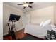 Bedroom featuring wood floors, ceiling fan, an exercise bike, and an open doorway to the bathroom at 1630 W Calle Del Norte --, Chandler, AZ 85224