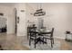 Charming dining room with seating for four, an elegant light fixture, and neutral tones for a sophisticated dining experience at 1630 W Calle Del Norte --, Chandler, AZ 85224