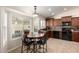 Eat-in kitchen area featuring a wood table and chairs, large windows for natural light and adjacent to kitchen amenities at 1630 W Calle Del Norte --, Chandler, AZ 85224