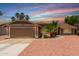 Charming single-story home featuring a well-manicured yard with mature trees, fresh gravel, and a two-car garage at 1630 W Calle Del Norte --, Chandler, AZ 85224