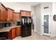 Efficient kitchen featuring dark wood cabinetry, granite countertops, and black appliances, offering style and functionality at 1630 W Calle Del Norte --, Chandler, AZ 85224