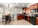 Well-lit kitchen with dark wood cabinets, a breakfast nook, and modern appliances at 1630 W Calle Del Norte --, Chandler, AZ 85224