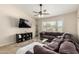 Comfortable living room with large window, plush sectional sofa, ceiling fan and media console at 1630 W Calle Del Norte --, Chandler, AZ 85224