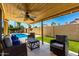 Cozy covered patio featuring comfortable seating and a ceiling fan, with a view of the pool and backyard at 1630 W Calle Del Norte --, Chandler, AZ 85224