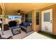 Relaxing covered patio with comfortable seating, ceiling fan, and views of the backyard, ideal for outdoor lounging at 1630 W Calle Del Norte --, Chandler, AZ 85224
