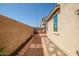 Enclosed backyard with a patio, stone pathway, and simple landscaping, great for outdoor relaxation at 17802 N 114Th Ln, Surprise, AZ 85378