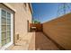 Private patio with brick pavers, outdoor grill, and tall wall for added privacy and security at 17802 N 114Th Ln, Surprise, AZ 85378