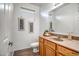 Bright bathroom featuring a wood vanity, framed art, and a toilet, complemented by a wood-look floor at 17802 N 114Th Ln, Surprise, AZ 85378