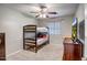 Cozy bedroom featuring a bunk bed, ceiling fan, carpet flooring, and a window with natural light at 17802 N 114Th Ln, Surprise, AZ 85378