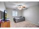 Cozy bedroom with neutral walls, carpeted floor, ceiling fan and natural light from the window at 17802 N 114Th Ln, Surprise, AZ 85378