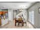 Dining area featuring a wooden table set, modern chandelier, and sliding glass doors for natural light at 17802 N 114Th Ln, Surprise, AZ 85378