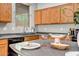 Kitchen island with oak cabinets, a built-in sink, and a decorative display at 17802 N 114Th Ln, Surprise, AZ 85378