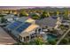 Aerial view of the backyard with a pool, patio, and solar panels on the roof at 18030 W Caribbean Ln, Surprise, AZ 85388
