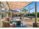 Inviting backyard with a covered patio, pool, manicured landscaping, and cozy seating areas at 18030 W Caribbean Ln, Surprise, AZ 85388
