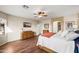 Stylish primary bedroom with hardwood floors, ceiling fan, and a double door closet for ample storage at 18030 W Caribbean Ln, Surprise, AZ 85388