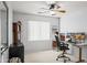 Bedroom/office features a ceiling fan and two monitors on a desk for work at home convenience at 18030 W Caribbean Ln, Surprise, AZ 85388