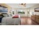 Comfortable primary bedroom with a large window view of the lush green backyard with a sparkling pool at 18030 W Caribbean Ln, Surprise, AZ 85388