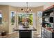 Bright dining area with a large window overlooking the backyard patio and garden at 18030 W Caribbean Ln, Surprise, AZ 85388