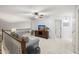 Inviting upstairs loft area featuring a comfortable sofa, a ceiling fan, and a television for relaxation at 18030 W Caribbean Ln, Surprise, AZ 85388