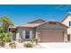 Attractive single-story home with a well-maintained front yard, desert plants, and a two-car garage at 18198 E El Viejo Desierto --, Gold Canyon, AZ 85118