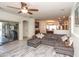 Open-concept living room with a large sectional couch, ceiling fan, and access to the patio at 18198 E El Viejo Desierto --, Gold Canyon, AZ 85118
