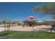 Community playground with a red shade structure, slides, and a bench for relaxation at 18198 E El Viejo Desierto --, Gold Canyon, AZ 85118