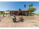 Charming backyard with a covered patio, desert landscaping, and a cozy fire pit area at 19302 W Melvin St, Buckeye, AZ 85326