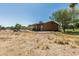 View of the backyard featuring a covered patio, desert landscaping, and a peaceful atmosphere at 19302 W Melvin St, Buckeye, AZ 85326