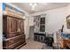 A bedroom featuring a large wardrobe, a window with blinds, and personal items at 19302 W Melvin St, Buckeye, AZ 85326