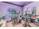 A bonus room includes exercise equipment, fishing poles, and a large picture window at 19302 W Melvin St, Buckeye, AZ 85326