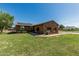Charming single story home with desert landscaping, solar panels and a large grassy front yard at 19302 W Melvin St, Buckeye, AZ 85326