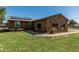Single-story home with solar panels, low-maintenance desert landscape, a long driveway and a big grassy yard at 19302 W Melvin St, Buckeye, AZ 85326