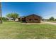 Charming single story home with solar panels, desert landscaping and a large grassy front yard at 19302 W Melvin St, Buckeye, AZ 85326