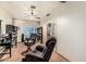 Living room featuring two recliner chairs, shelving, and a ceiling fan at 19302 W Melvin St, Buckeye, AZ 85326
