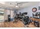 Laminate-floored office with neutral walls, a ceiling fan and multiple work spaces at 19302 W Melvin St, Buckeye, AZ 85326