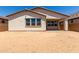 A backyard view showcasing the home's exterior features and large windows illuminating interior spaces at 19338 S 212Th Pl, Queen Creek, AZ 85142