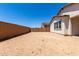 A partially fenced backyard featuring a partially completed exterior, new construction, and a future outdoor space at 19338 S 212Th Pl, Queen Creek, AZ 85142