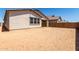 The backyard of the property featuring a block wall, new construction, and an attached two car garage at 19338 S 212Th Pl, Queen Creek, AZ 85142