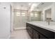 Elegant bathroom with double sink vanity, large mirror, and spacious glass shower at 19338 S 212Th Pl, Queen Creek, AZ 85142