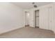 Spacious bedroom featuring carpeted floors, sliding door closet, and base trim at 19338 S 212Th Pl, Queen Creek, AZ 85142