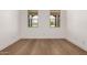 Bright bedroom with hardwood floors and two windows providing natural light at 19338 S 212Th Pl, Queen Creek, AZ 85142