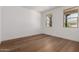 Inviting bedroom featuring hardwood floors and two windows for natural sunlight at 19338 S 212Th Pl, Queen Creek, AZ 85142