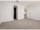 Neutral bedroom featuring carpet floors, base trim, and two door entrances at 19338 S 212Th Pl, Queen Creek, AZ 85142