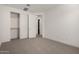 Bedroom featuring carpeted floors, closet with sliding doors, and base trim at 19338 S 212Th Pl, Queen Creek, AZ 85142