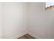 Bright corner space showcases sleek baseboards and light wood-look flooring with a partially visible transom window at 19338 S 212Th Pl, Queen Creek, AZ 85142