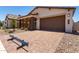 Beautiful home with brick details, desert landscaping, paver driveway, and a two-car garage at 19338 S 212Th Pl, Queen Creek, AZ 85142